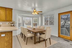 VIRTUALLY STAGED Dining space featuring a ceiling fan