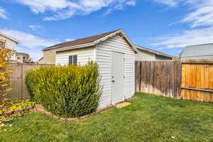 View of shed with a fenced backyard