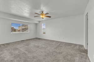 Unfurnished room with light carpet and ceiling fan