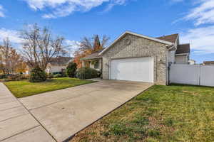 View of front of home with a garage, driveway, and brick siding