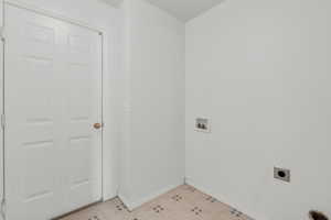 Laundry room featuring washer hookup and baseboards