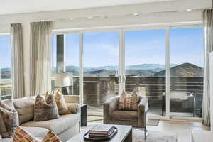 Sunroom with a mountain view and healthy amount of natural light