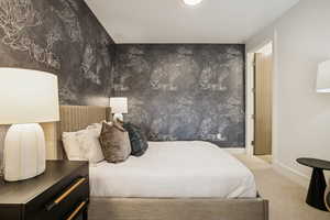 Carpeted bedroom featuring wallpapered walls and recessed lighting