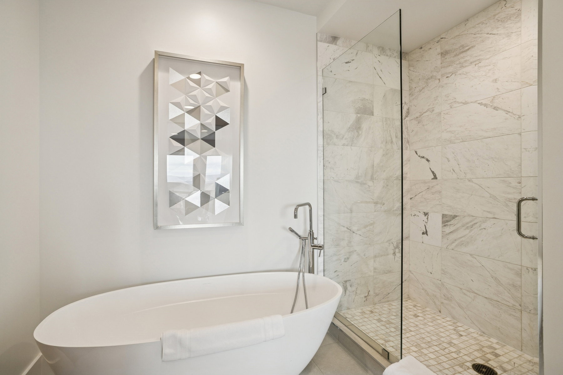 Full bath featuring a freestanding tub and a shower stall