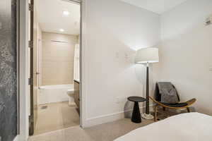 Bedroom with light tile patterned floors and recessed lighting