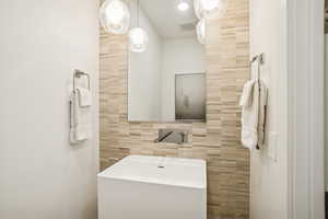 Bathroom with tile walls and vanity