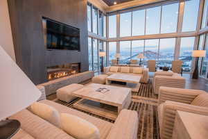 Common area featuring expansive windows, a towering ceiling, and recessed lighting