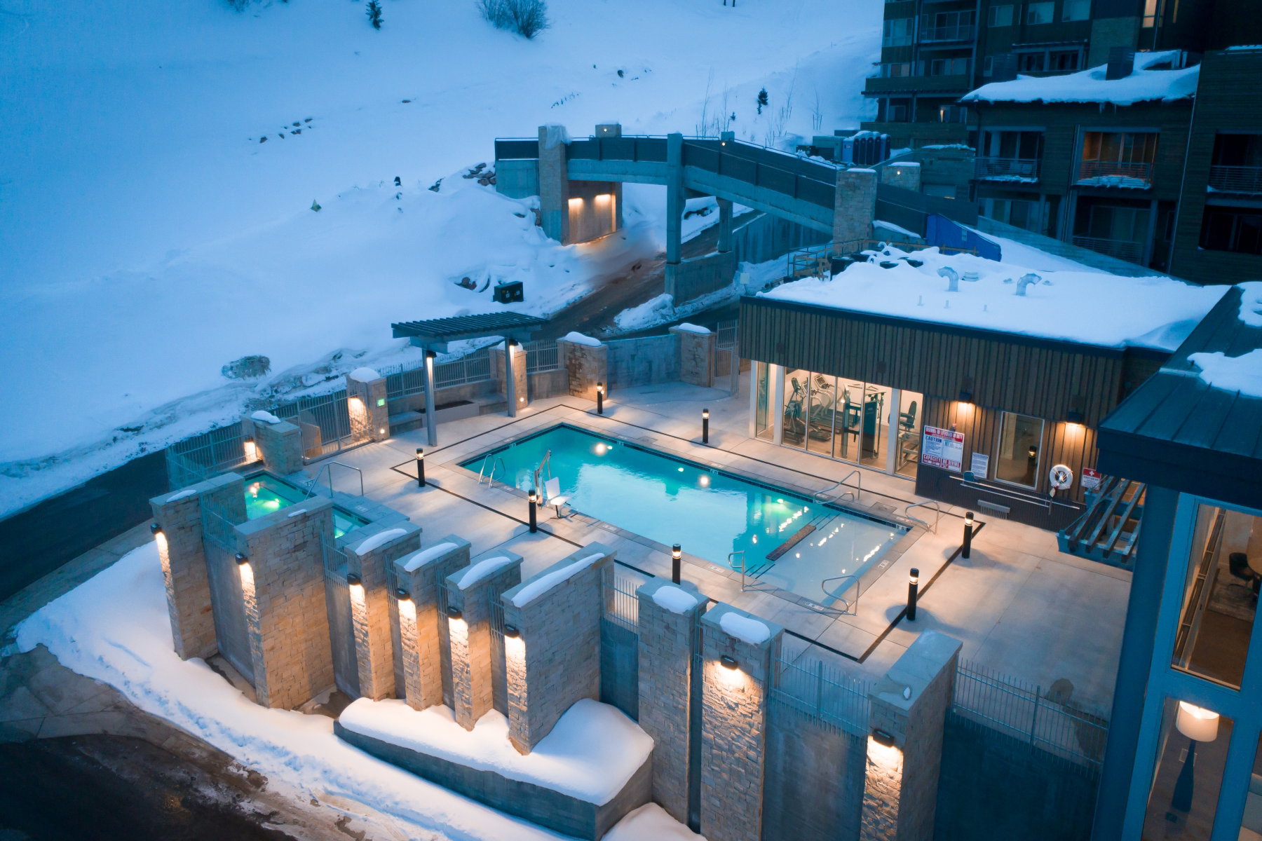 Snow covered pool with a patio area, a community pool, and a pergola