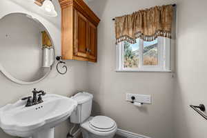 Half bath featuring a sink and toilet