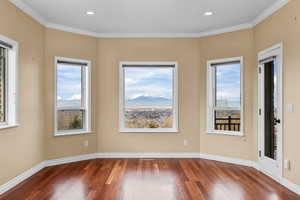Master Suite with hardwood / wood-style floors, a mountain view, ornamental molding, and recessed lighting