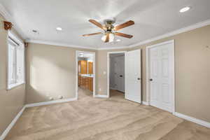 Unfurnished bedroom with crown molding, light carpet, ceiling fan, a textured ceiling, and recessed lighting