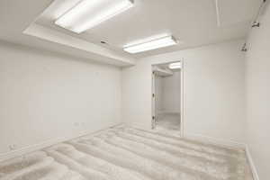 Carpeted empty room with baseboards and a textured ceiling