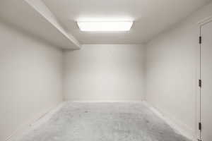 Empty room featuring a textured ceiling and unfinished concrete flooring
