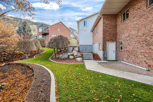 View of grassy yard featuring a patio