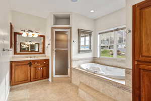 Bathroom with vanity, a garden tub, light tile patterned floors, a stall shower, and recessed lighting