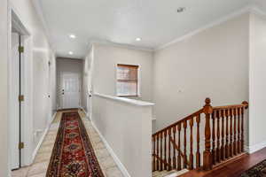 Hall featuring ornamental molding, an upstairs landing, recessed lighting, and tile  floors