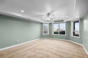 Carpeted spare room featuring recessed lighting and ceiling fan