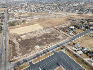 Aerial view of property and surrounding area with nearby suburban area