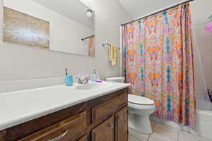 Bathroom featuring light tile patterned floors, vanity, and shower / bath combo