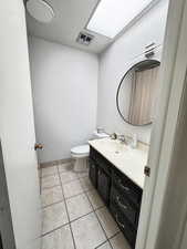 Bathroom with vanity and light tile patterned floors