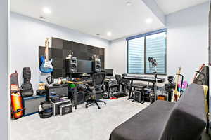 Carpeted home office featuring recessed lighting