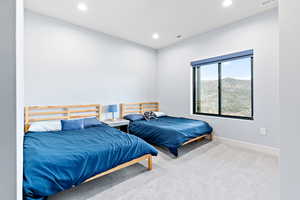 Carpeted bedroom featuring recessed lighting and a mountain view