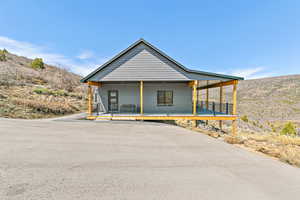 View of side of home with covered porch