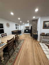 Dining space with light wood finished floors and recessed lighting