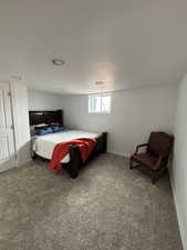 Bedroom featuring carpet and baseboards