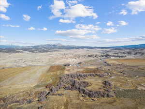 Aerial overview of property's location featuring rural landscape and a mountainous background