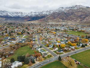 Aerial view of property's location featuring mountains and nearby suburban area