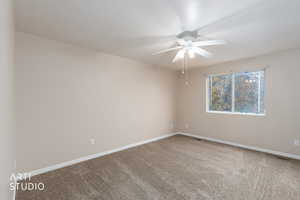 Unfurnished room with light carpet and a ceiling fan