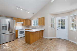 Kitchen with light countertops, stainless steel refrigerator with ice dispenser, decorative light fixtures, a peninsula, and white electric range oven