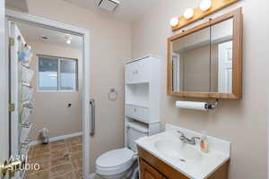 Full bathroom with vanity, a textured ceiling, and a shower with shower curtain