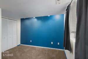 Unfurnished bedroom with carpet floors, a closet, and a textured ceiling
