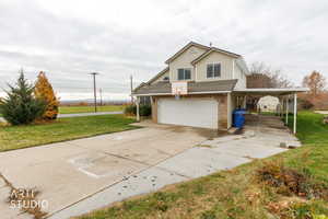 View of front of house with a front lawn, concrete driveway, brick siding, roof with shingles, and a garage
