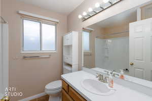Bathroom featuring vanity, a shower with shower curtain, and dark tile patterned floors