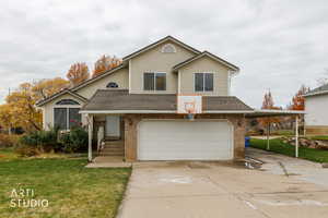 View of front of property with roof with shingles, brick siding, a front lawn, and concrete driveway