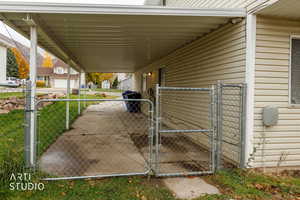 View of patio / terrace featuring a gate and an attached carport