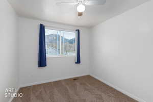 Spare room with carpet flooring and ceiling fan