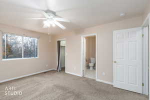 Unfurnished bedroom with a walk in closet, carpet floors, a ceiling fan, and connected bathroom