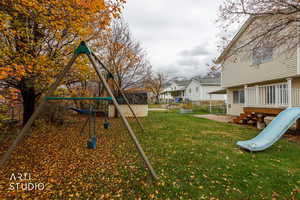 View of yard featuring a playground, a residential view, and a deck
