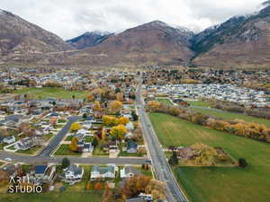 Aerial overview of property's location with nearby suburban area and a mountainous background