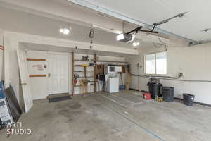Garage featuring washer / dryer and a garage door opener