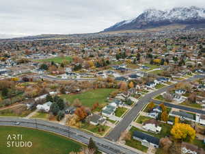 Aerial view of property's location featuring nearby suburban area and mountains