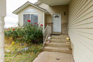 Doorway to property with stone siding