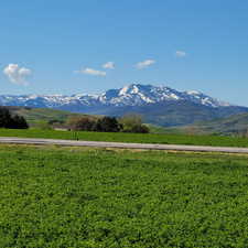 View of mountain background featuring rural landscape
