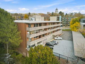 View of apartment building / complex with uncovered parking