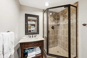 Bathroom featuring vanity and a shower stall