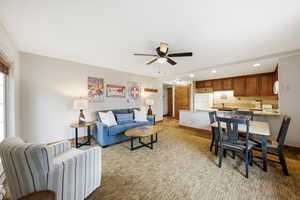 Living room featuring recessed lighting, a ceiling fan, and light colored carpet